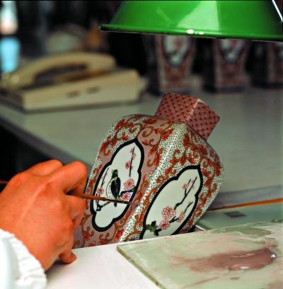 Hand-painting a traditional ceramic piece